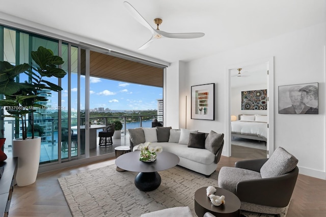 living room featuring parquet floors, ceiling fan, and expansive windows