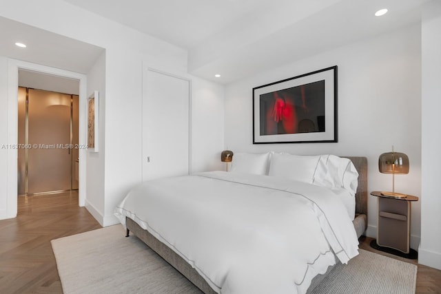 bedroom featuring parquet flooring