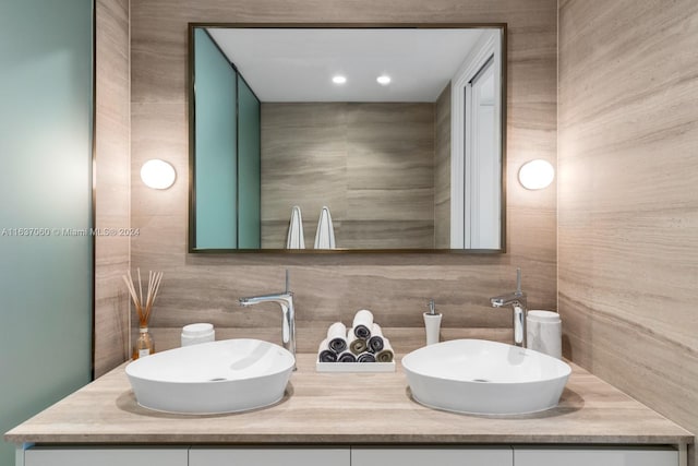 bathroom featuring vanity and backsplash