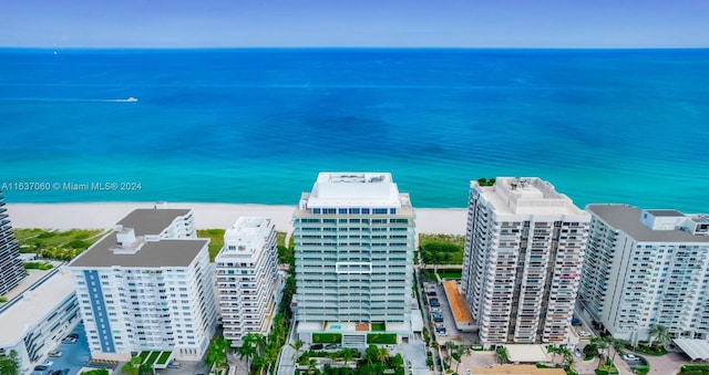 birds eye view of property with a water view and a beach view