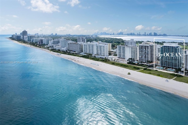 drone / aerial view featuring a view of the beach and a water view