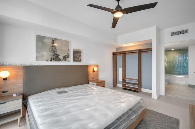 tiled bedroom with ensuite bath, a closet, and ceiling fan