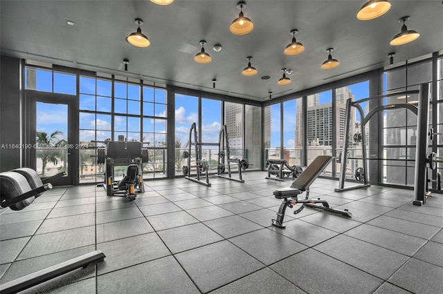 workout area with tile patterned floors, french doors, and floor to ceiling windows