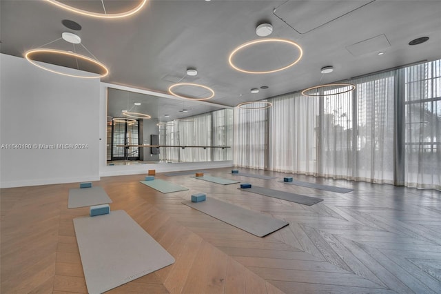 exercise room featuring parquet floors