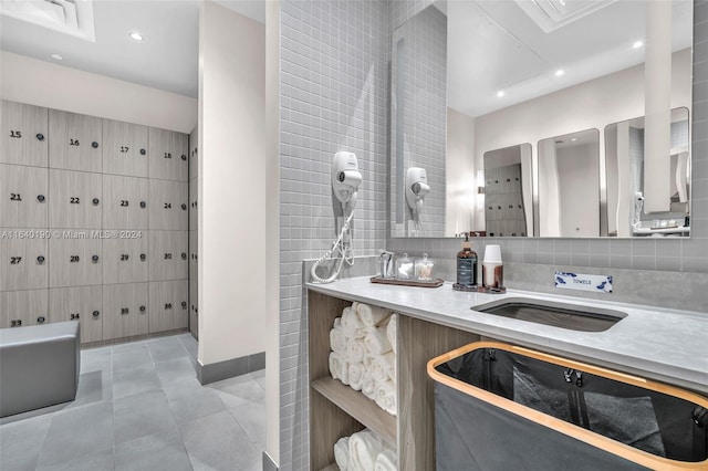 bathroom with tasteful backsplash and tile patterned flooring