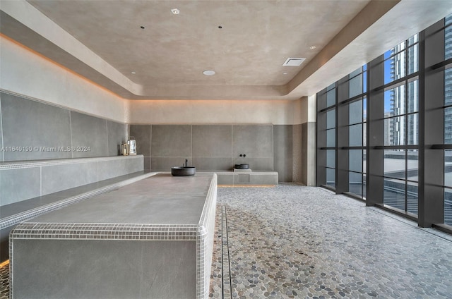 interior space featuring tile patterned floors and a tray ceiling