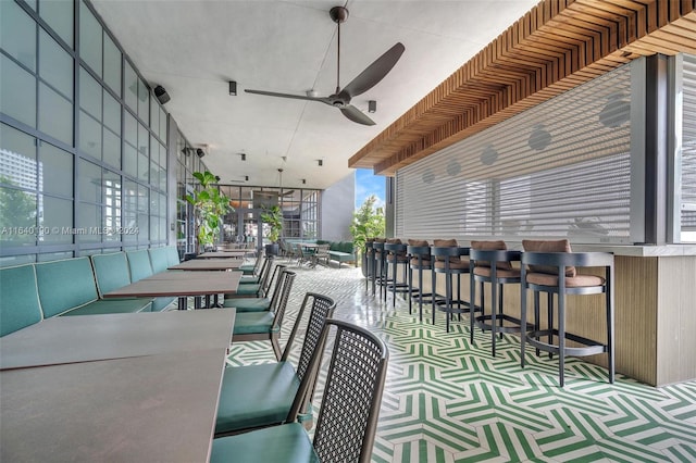 view of patio / terrace with an outdoor bar and ceiling fan