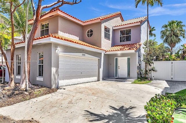 mediterranean / spanish home with a garage