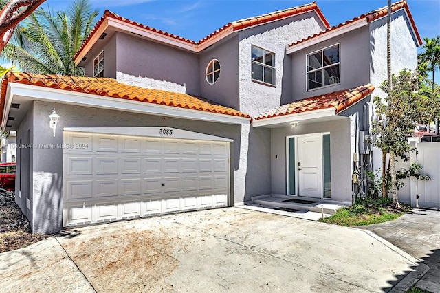 mediterranean / spanish home featuring a garage