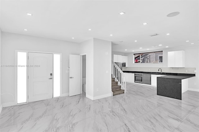 kitchen with white cabinets, appliances with stainless steel finishes, and sink