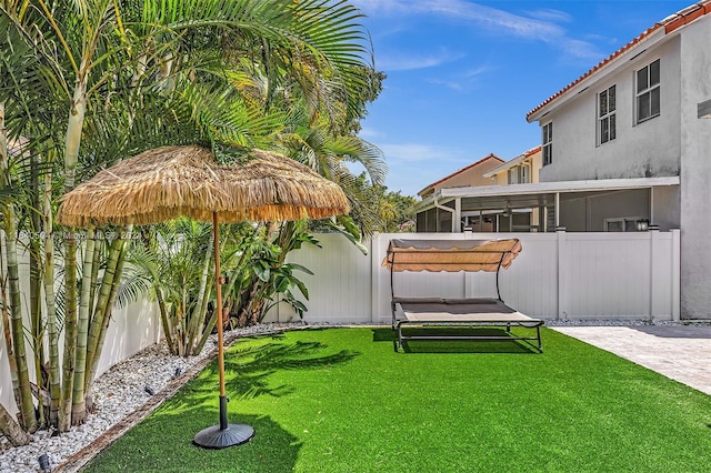 view of yard featuring a sunroom and a patio area