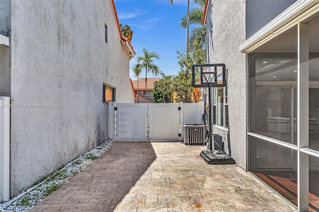 view of side of property featuring central AC unit and a patio area