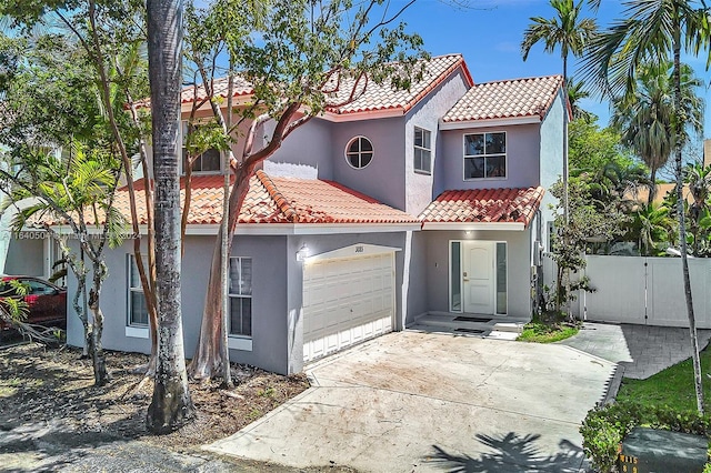 mediterranean / spanish house featuring a garage