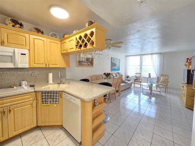 kitchen featuring ceiling fan, white appliances, light tile patterned flooring, tasteful backsplash, and sink