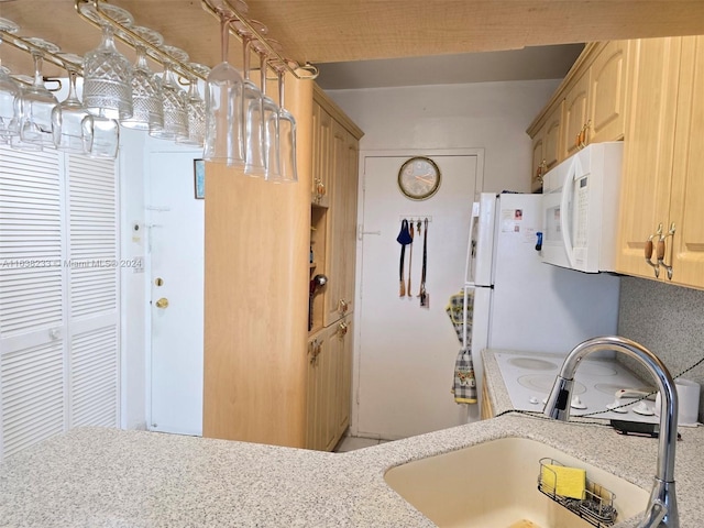 kitchen with sink and light brown cabinetry