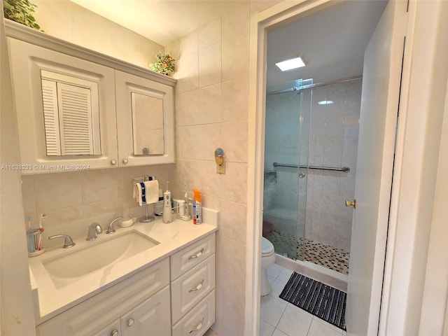 bathroom with toilet, tile walls, an enclosed shower, tile patterned floors, and vanity