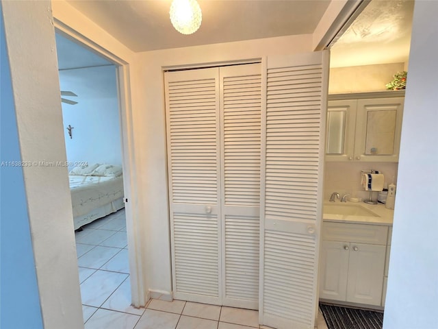 bathroom with vanity, tasteful backsplash, and tile patterned flooring