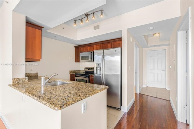 kitchen featuring tile patterned floors, appliances with stainless steel finishes, sink, and rail lighting