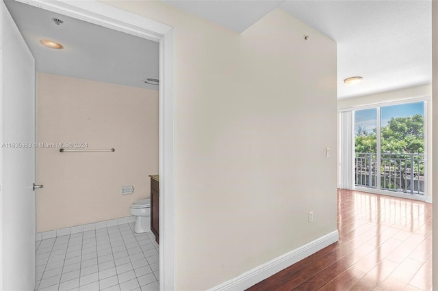 hallway with tile patterned flooring