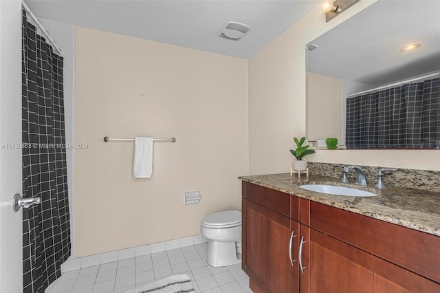 bathroom featuring toilet, vanity, and tile patterned flooring