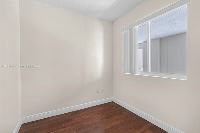 spare room with wood-type flooring and a textured ceiling