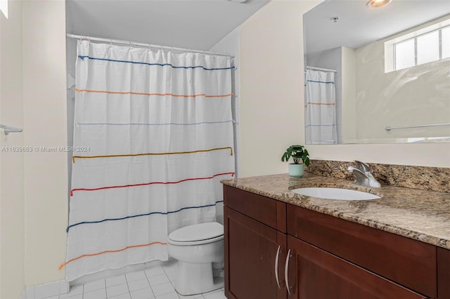 bathroom featuring vanity, toilet, and tile patterned flooring