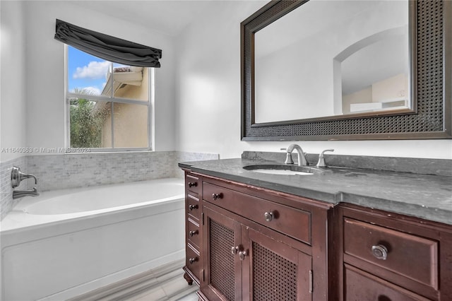 bathroom featuring vanity and a tub to relax in