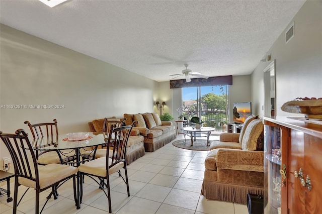 living room featuring visible vents, ceiling fan, a textured ceiling, and light tile patterned floors