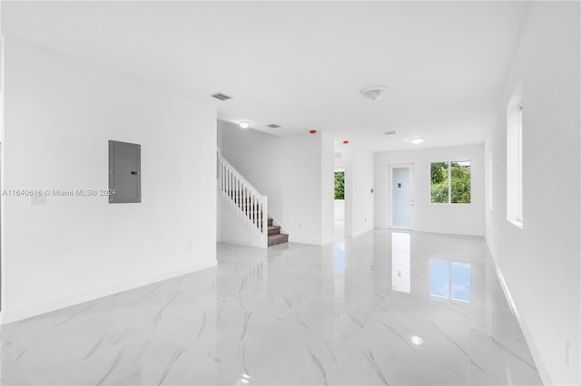 spare room with light tile patterned floors and electric panel