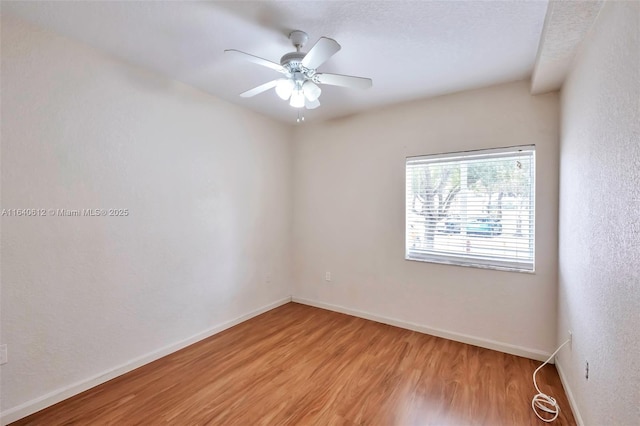 spare room featuring ceiling fan and light wood-type flooring