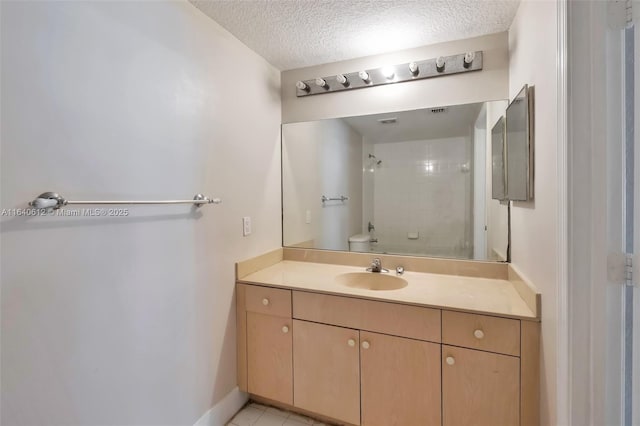 bathroom featuring vanity, tile patterned floors, toilet, a textured ceiling, and walk in shower