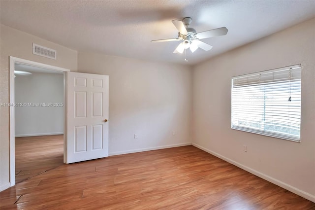 unfurnished room featuring ceiling fan and light hardwood / wood-style floors