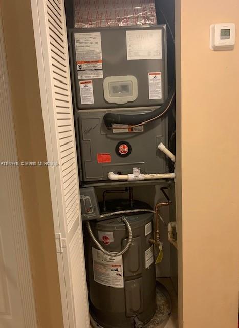 utility room featuring heating unit