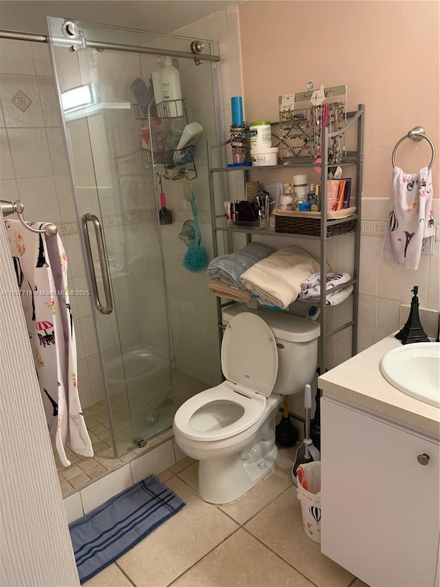 bathroom with walk in shower, tile patterned floors, toilet, and vanity