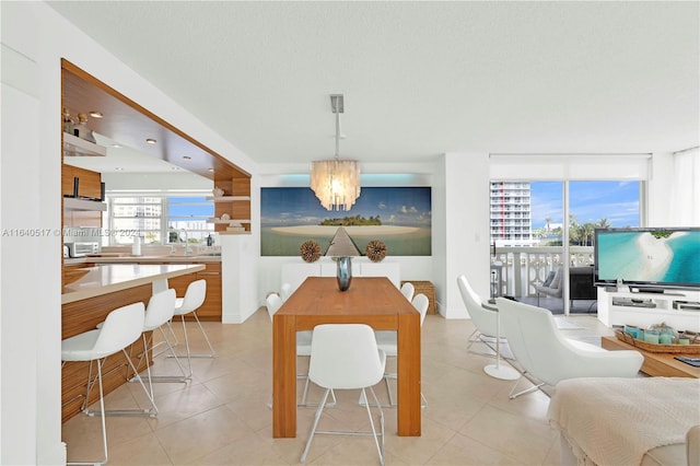 dining area featuring a notable chandelier and light tile patterned floors