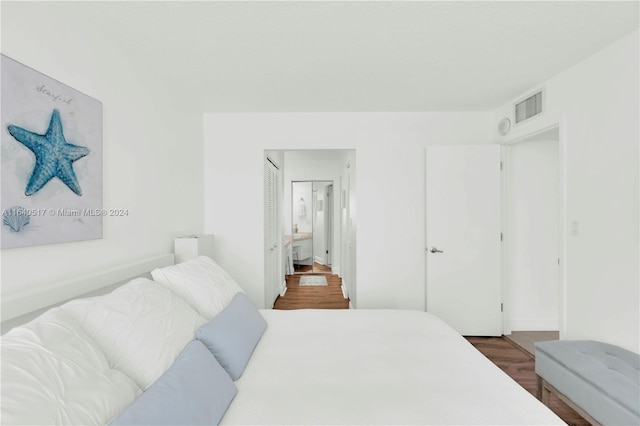 bedroom with a closet and wood-type flooring