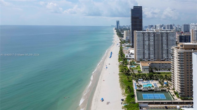 birds eye view of property featuring a water view and a beach view