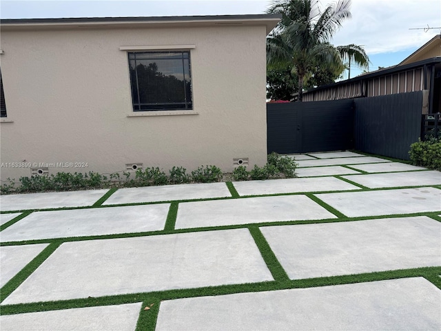 view of side of property with a patio area