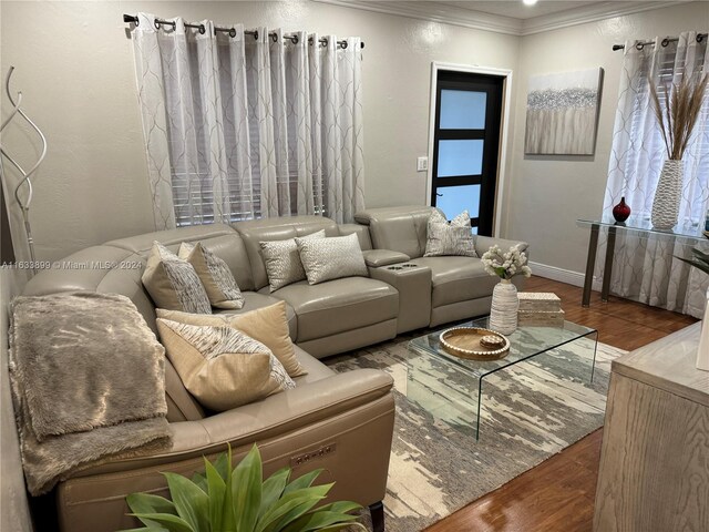 living room featuring hardwood / wood-style flooring and ornamental molding