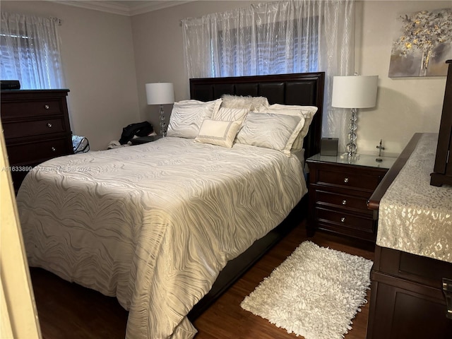 bedroom featuring dark hardwood / wood-style floors and crown molding