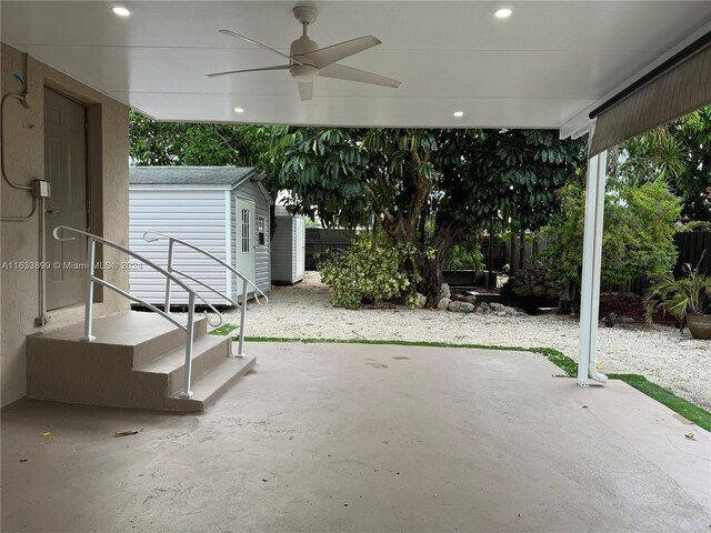 view of patio / terrace featuring ceiling fan and a storage shed