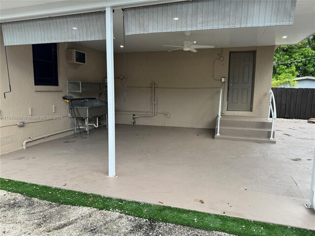 view of patio featuring an AC wall unit and ceiling fan