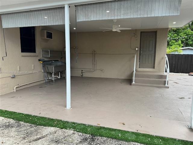 view of patio / terrace with a wall mounted AC and ceiling fan