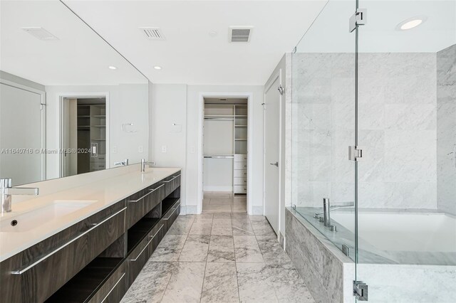 bathroom featuring dual bowl vanity and tile patterned flooring