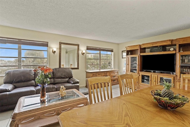 tiled living room featuring a textured ceiling