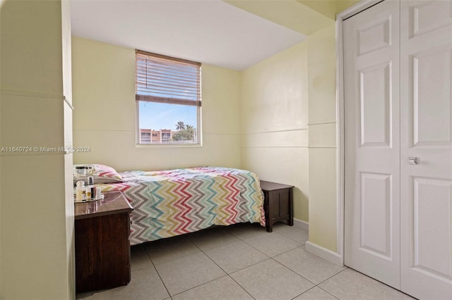 tiled bedroom with a closet