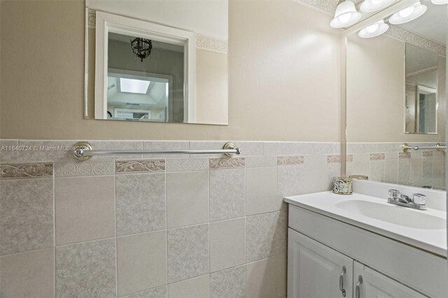 bathroom with tile walls and vanity