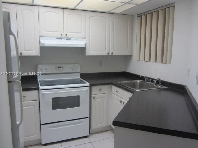 kitchen with sink, white cabinetry, and white electric range