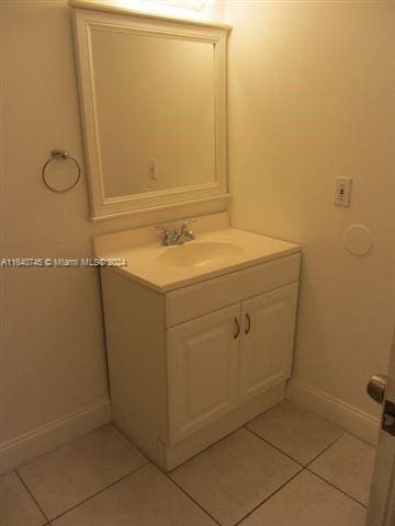 bathroom featuring tile patterned flooring and vanity