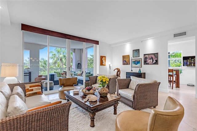 living room featuring light tile patterned flooring and floor to ceiling windows